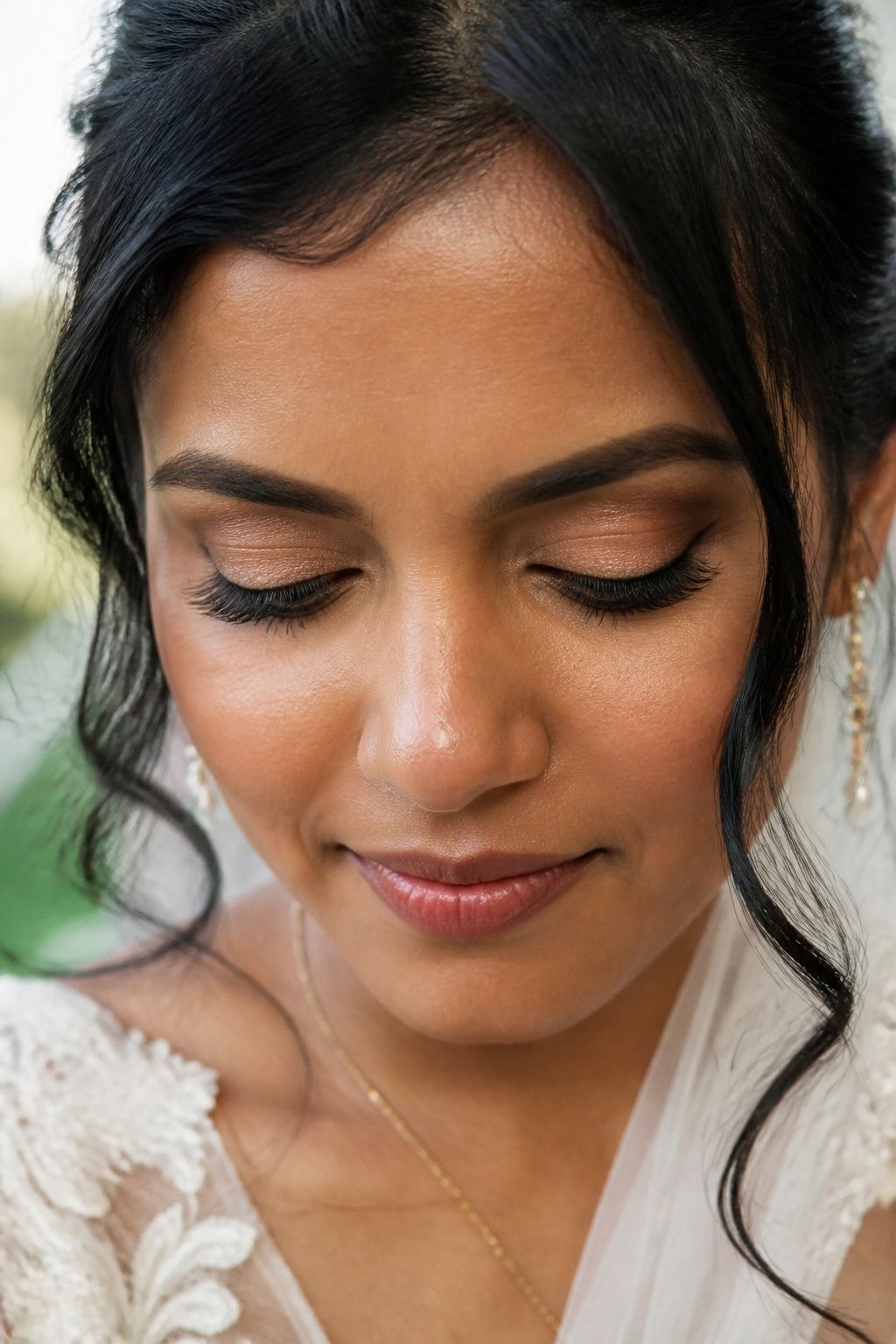 Tapered individual bridal lashes shown with eyes lowered.