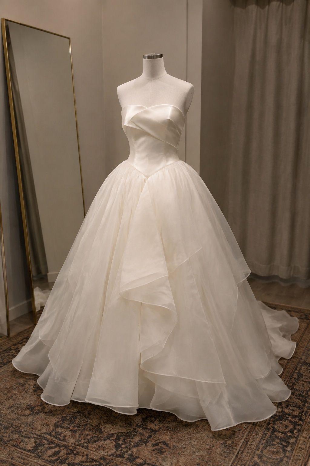 Strapless bridal gown with a structured satin bodice and layered organza skirt