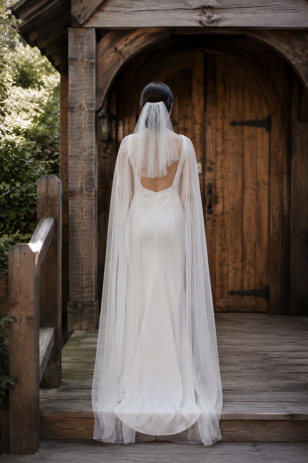Bride wearing a veil and cape together