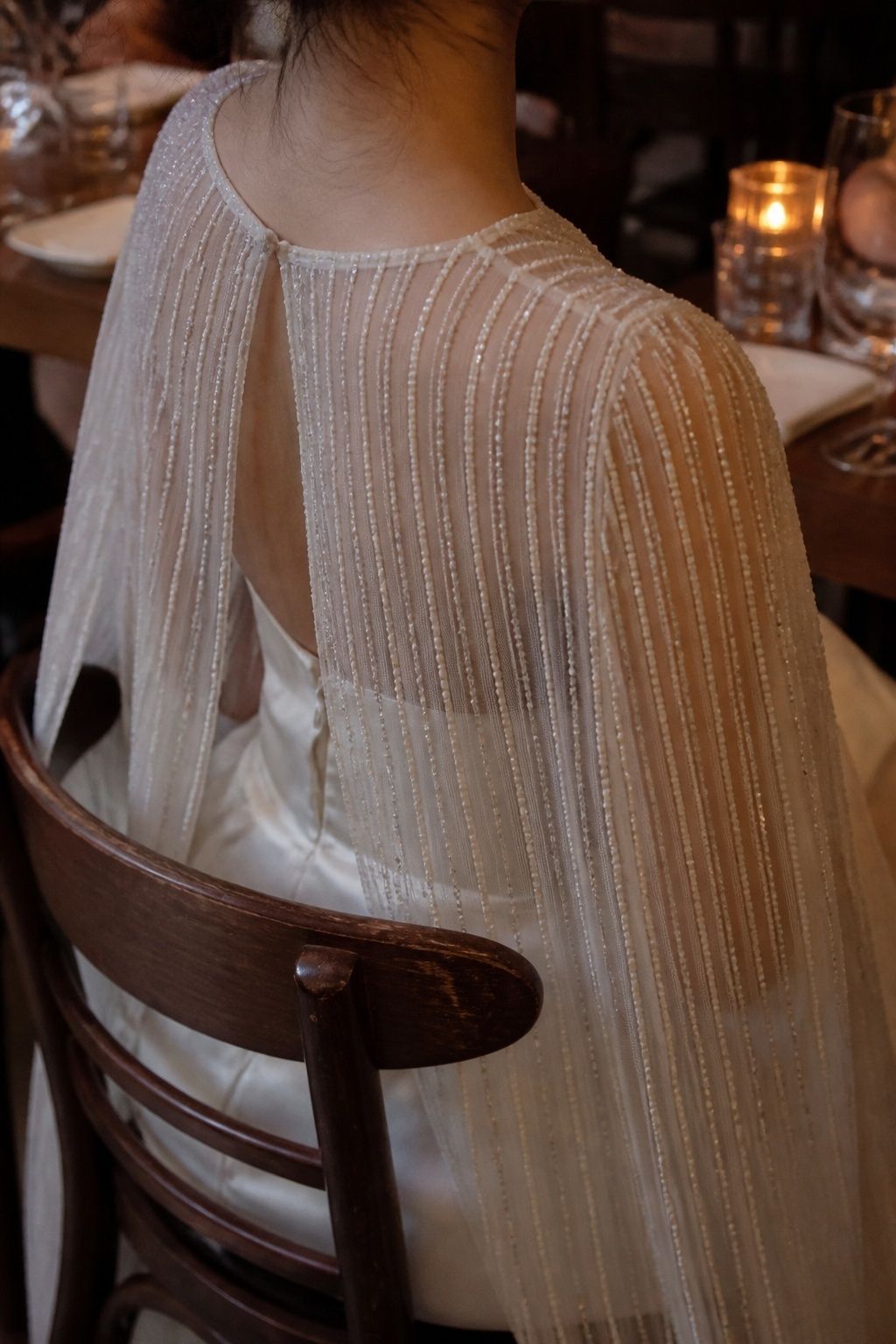 Beaded cape at an evening restaurant wedding