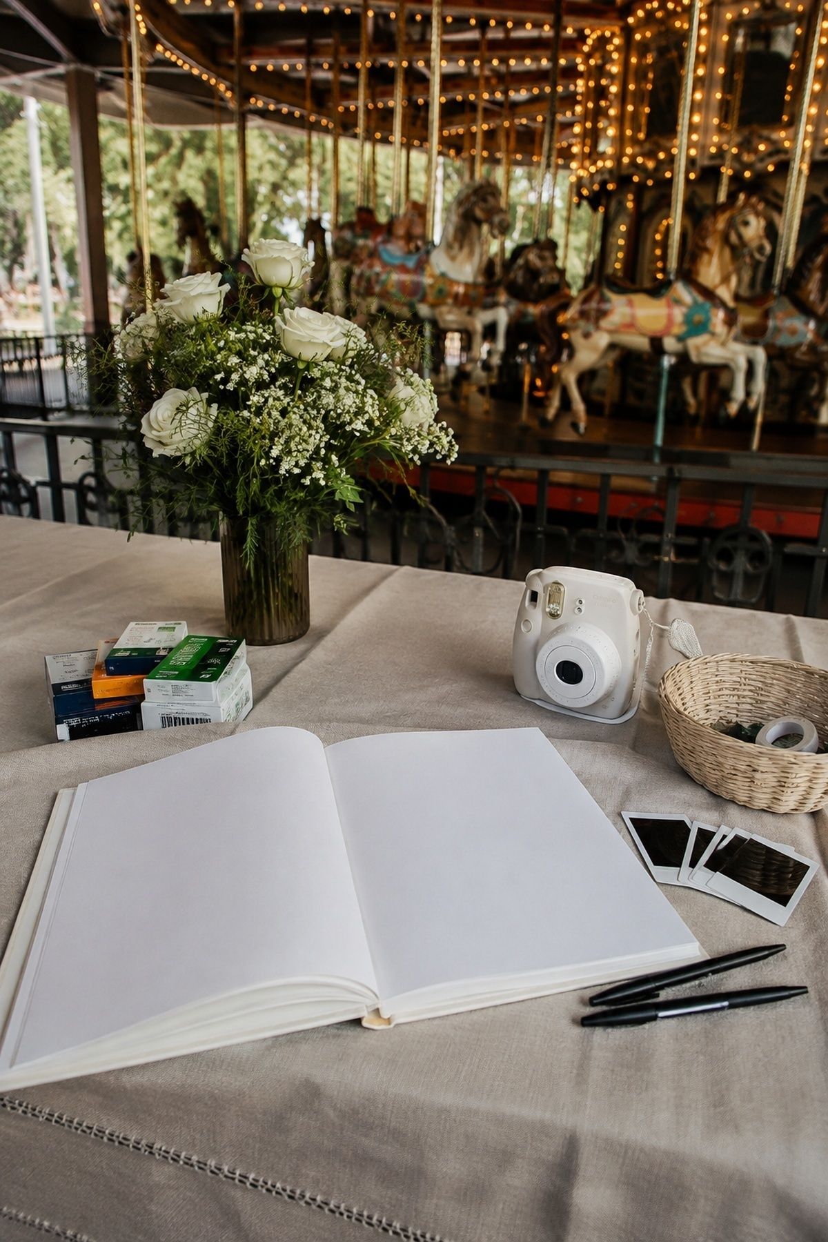 Carousel wedding photo guest book station with instant camera and supplies