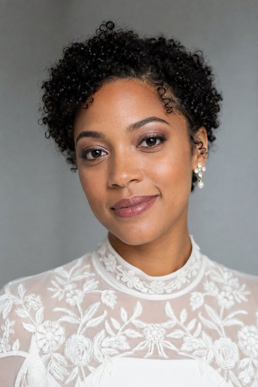 Bride with softly set skin, plum-taupe eyes and a mauve lip.
