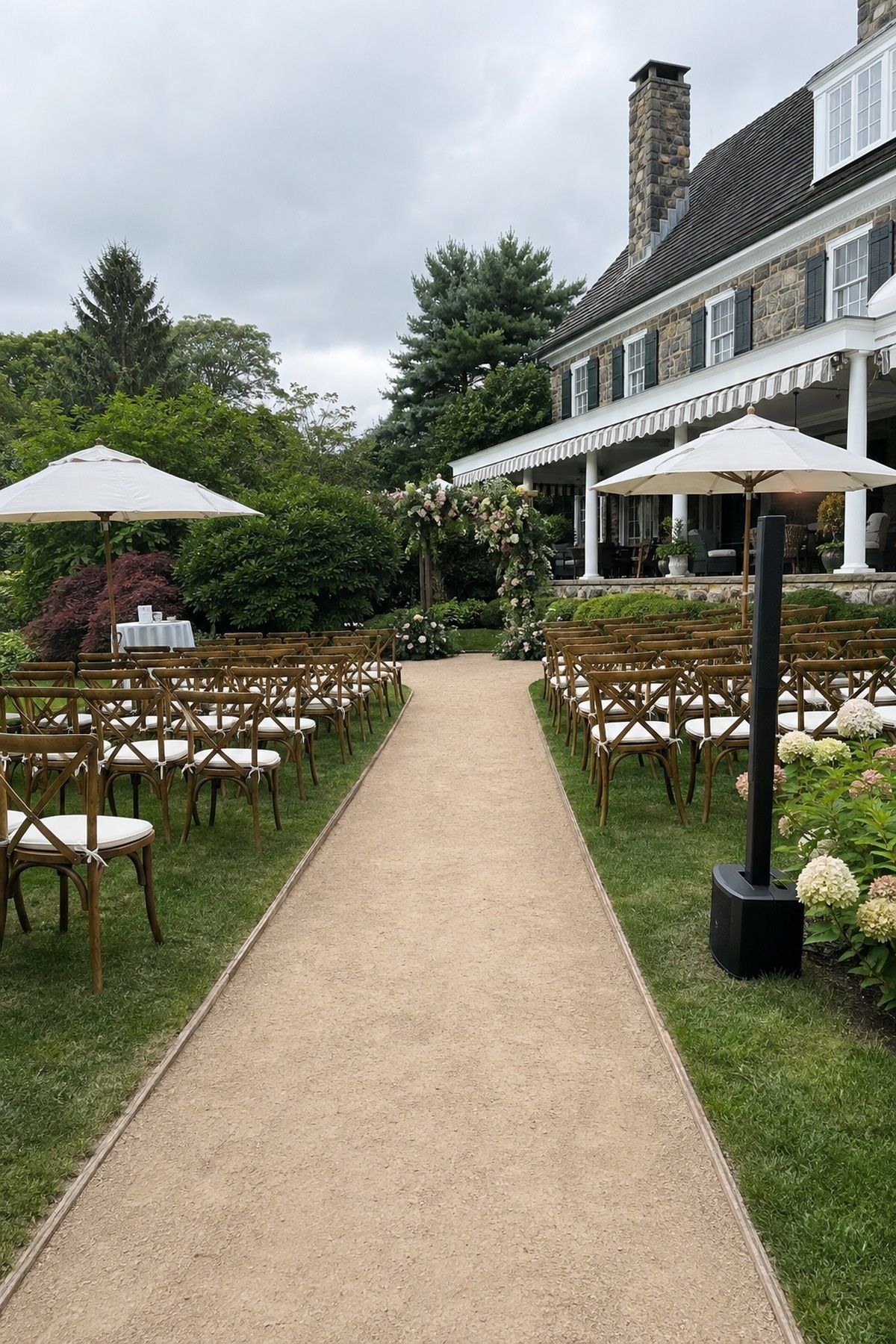 Accessible garden wedding ceremony with level path, comfortable seating, shade and a discreet speaker