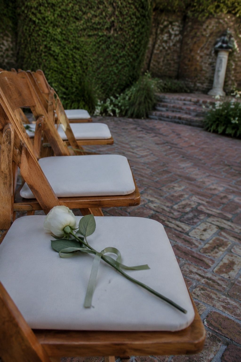 A white rose on a ceremony chair honoring an absent loved one