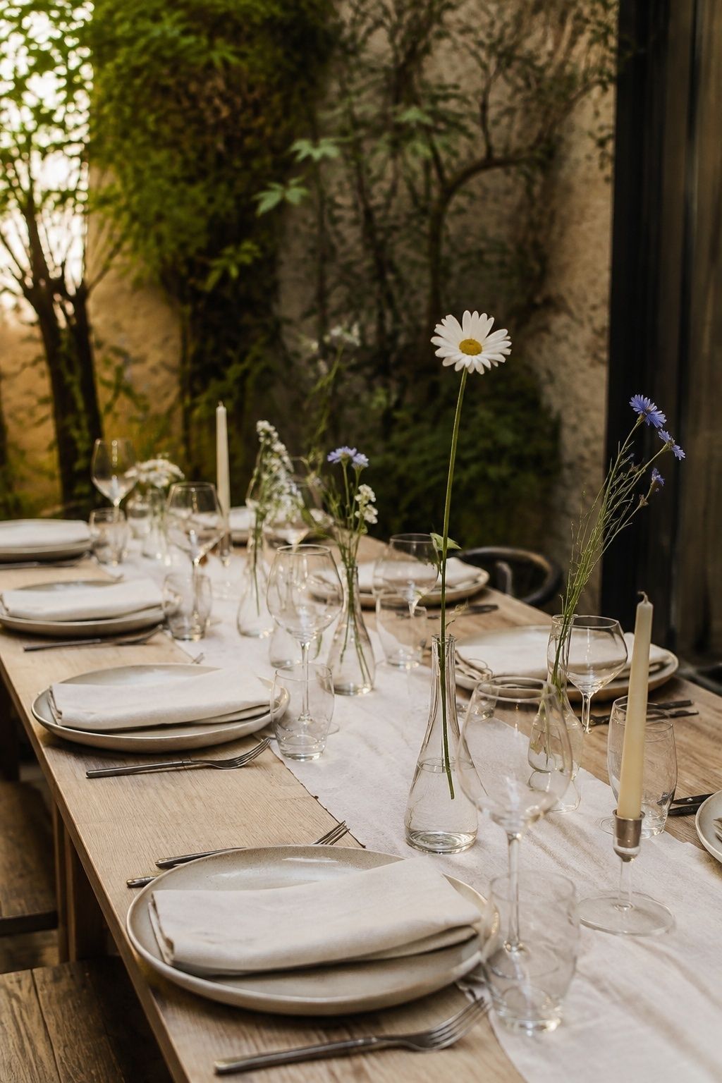 Bud vases of wildflowers on reception tables