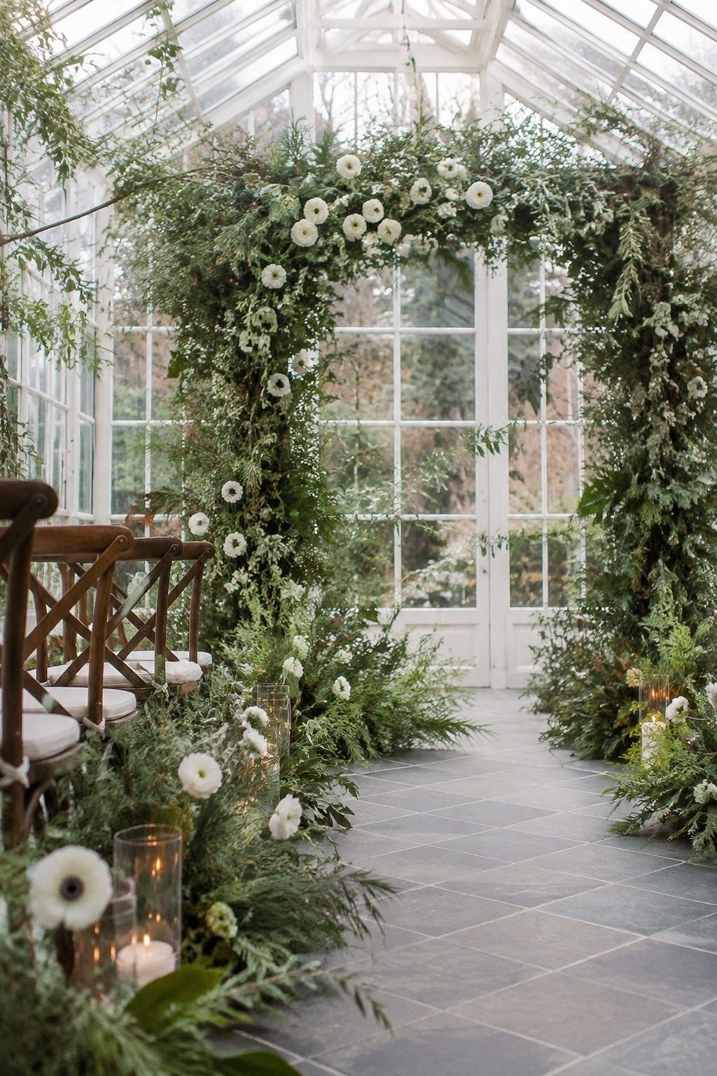 Green winter wedding ceremony arch with white flowers